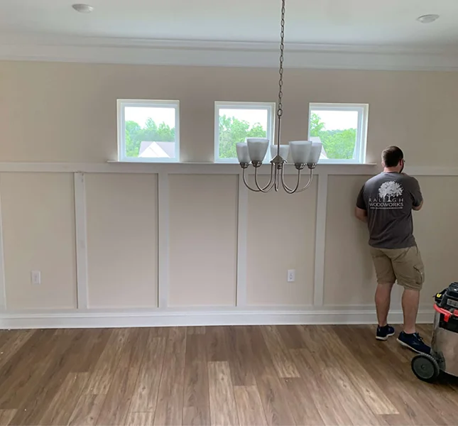 Hallway with crown molding, baseboards and cased interior doors