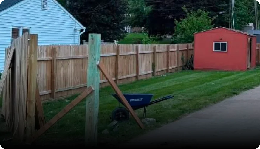 Cedar board privacy fence with a gate and black hardware