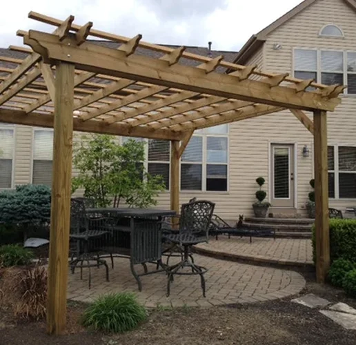 Wooden pergola over a paver patio with table and chairs